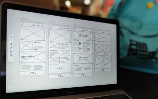 image of laptop screen with wireframes of a website planning out how a website should look