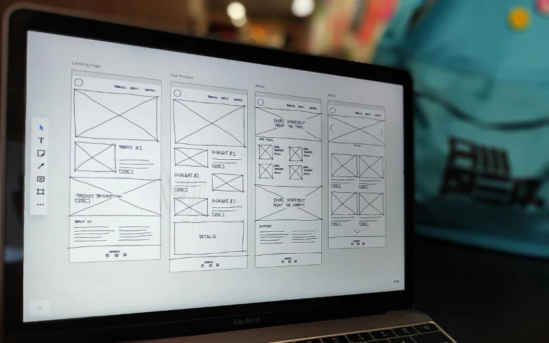 image of laptop screen with wireframes of a website planning out how a website should look